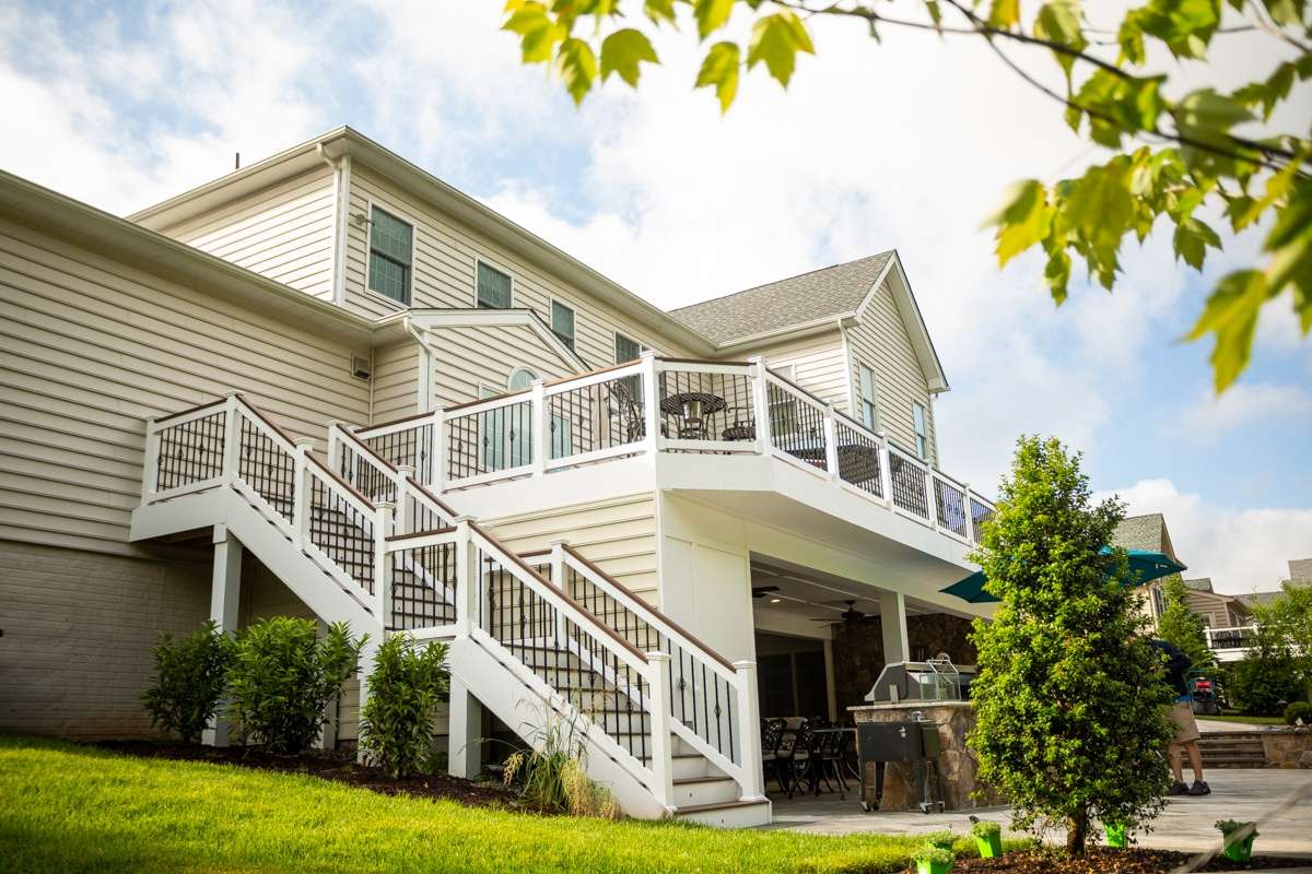 deck off home with landscaping and paver patio