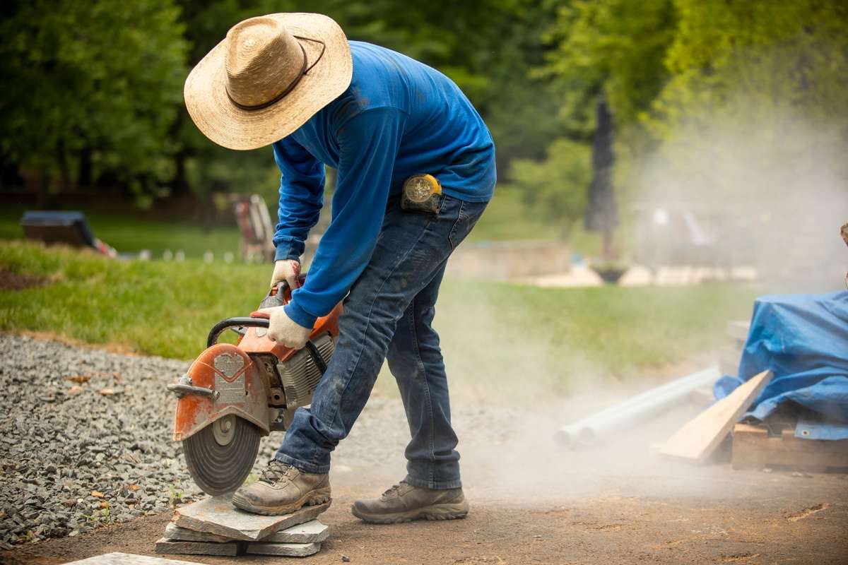 hardscaping worker with saw