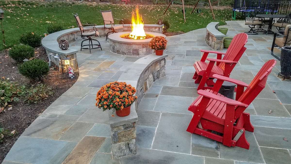 fire pit on natural paver patio with seating