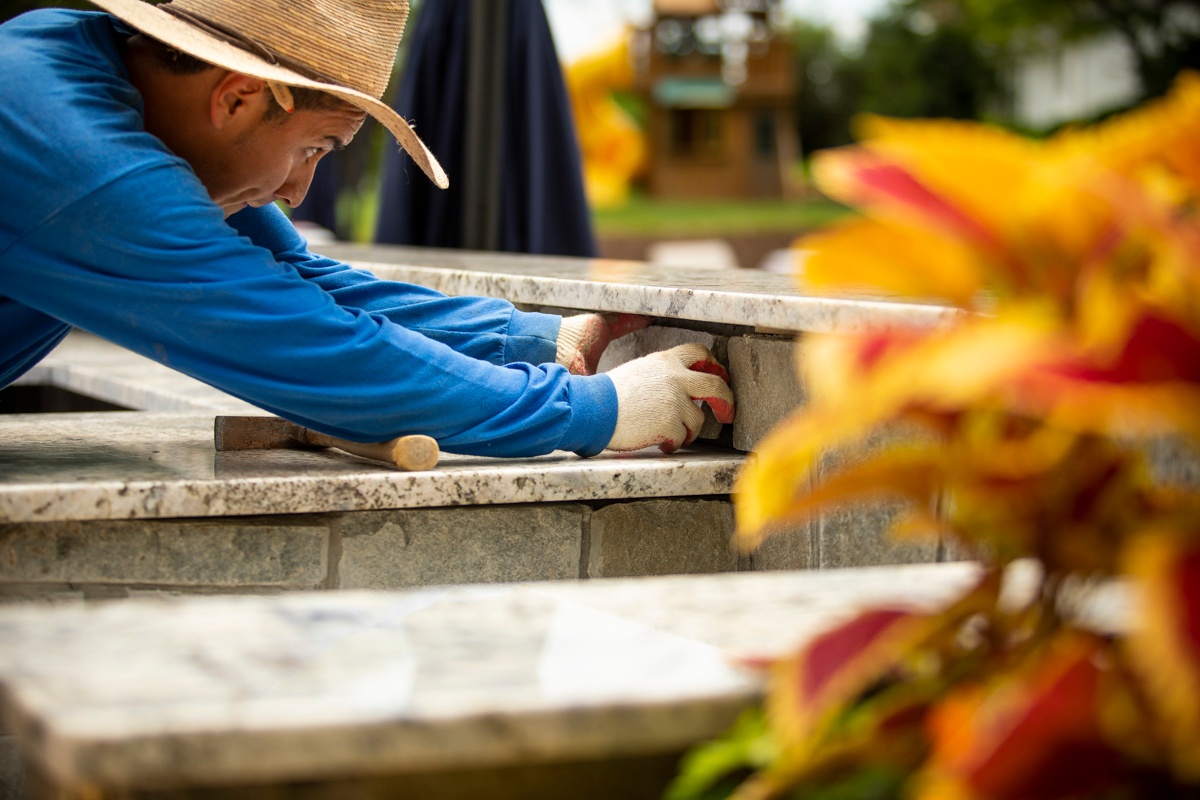 hardscaping masonry worker with mortar 2