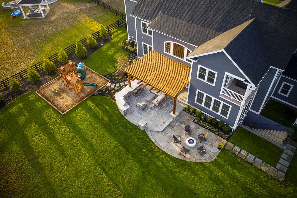 Landscape design with patio, pergola, and lawn