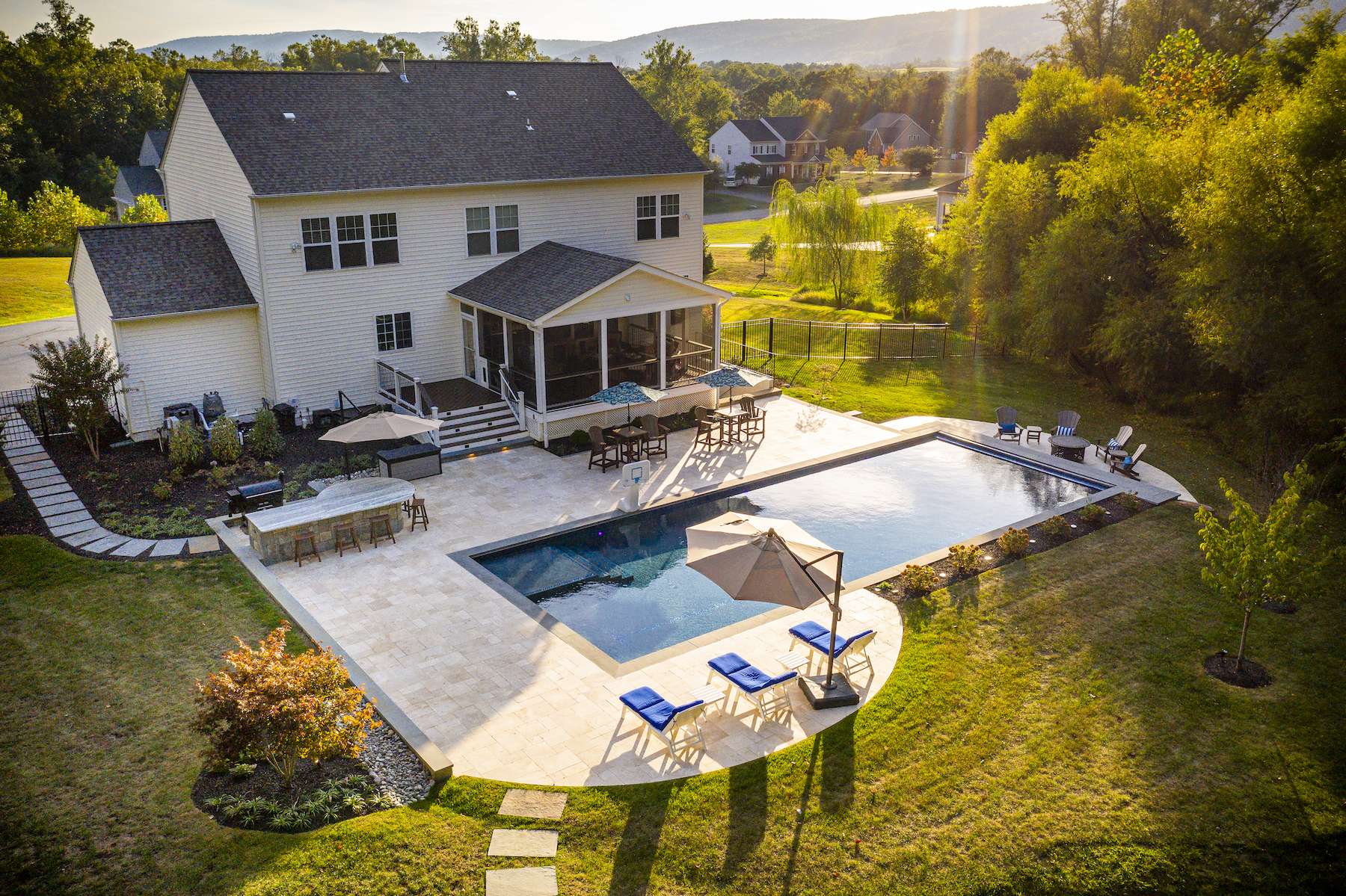 custom pool with paver patio and seating area